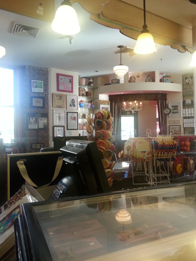 Behind the sign at the cake ordering side of the bakery.